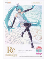Good Smile Company Racing Miku 2013 Ver. figure packaging artwork, showing the character in a white and silver racing outfit with long turquoise hair, black gloves, and black thigh-high boots against a pale background with track imagery.