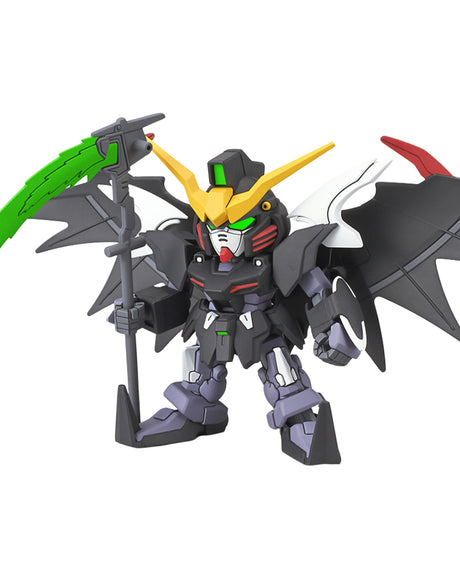 A small mecha toy figure with a dark gray body, yellow horns, green eyes, black wings, and a green-and-gray scythe, shown on a plain white background.
