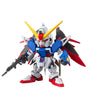 A small multicolor Gundam figurine holding a rifle, featuring a white, blue, red, and yellow color scheme, isolated on a white background.