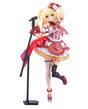A collectible anime figurine of a blonde female singer character in a red and white costume, posed next to a black microphone stand on a plain white background.
