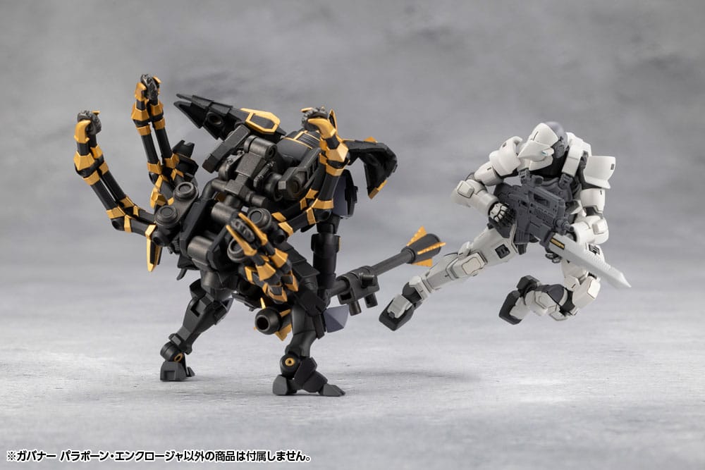 Two robot action figures, one black and yellow, the other white and gray, on a gray background.